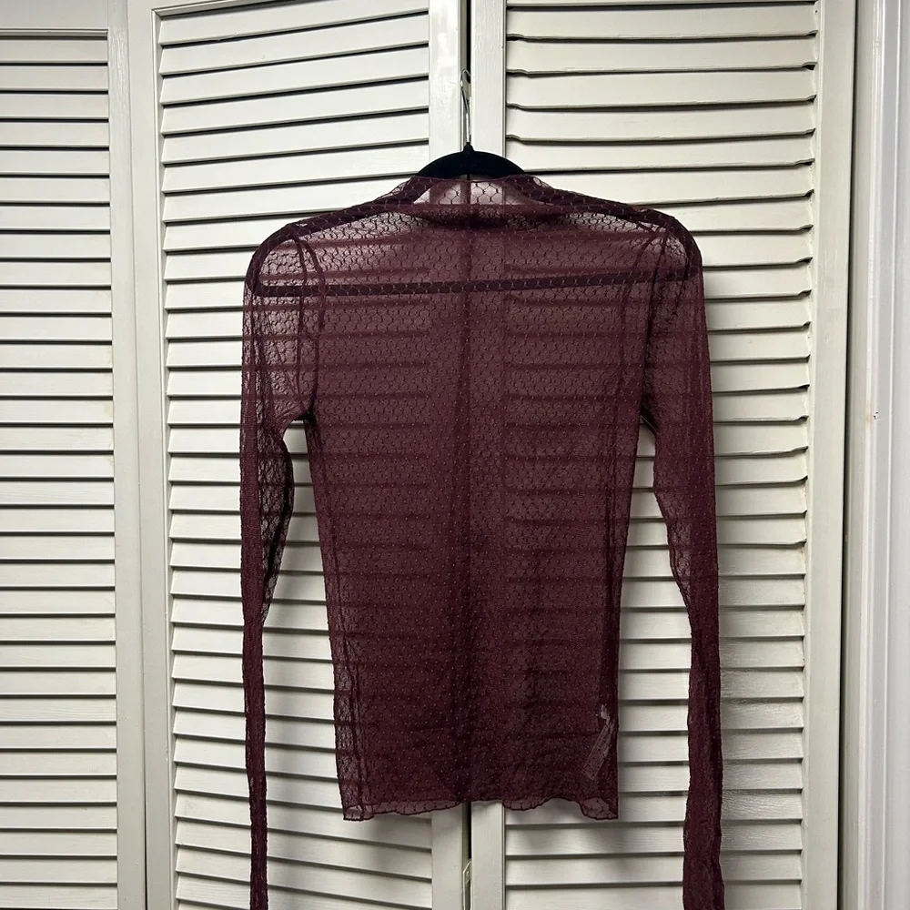 NWOT Free People minding my business top NWOT plum, black and pink available