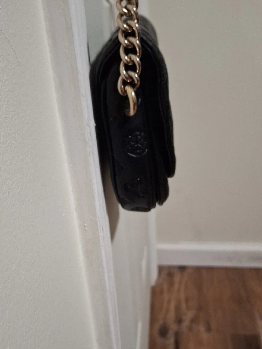 GUESS Black Embossed Leather Shoulder Bag with Gold Chain and Charm Accent